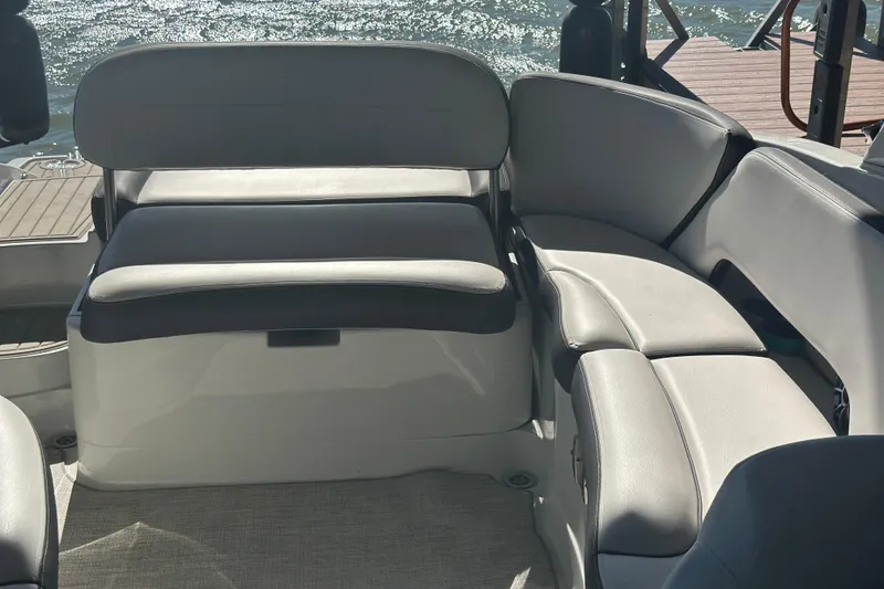 Slide: The Image of 2023 Crownline 290 CR boat interior with sleek, modern seating and waterfront view. - 18