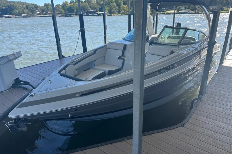 Slide: The Image of 2023 Crownline 290 CR boat docked on a sunny lake. - 28