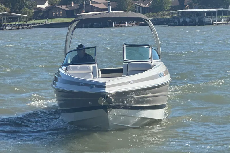 Slide: The Image of 2023 Crownline 290 CR boat cruising on a sunny lake. - 31