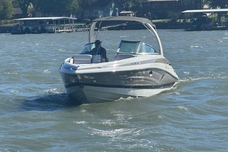 Slide: The Image of 2023 Crownline 290 CR boat cruising on a sunny lake. - 32