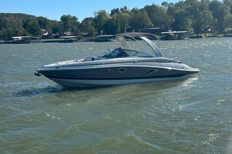 Slide: The Image of 2023 Crownline 290 CR boat cruising on a sunny lake. - 34
