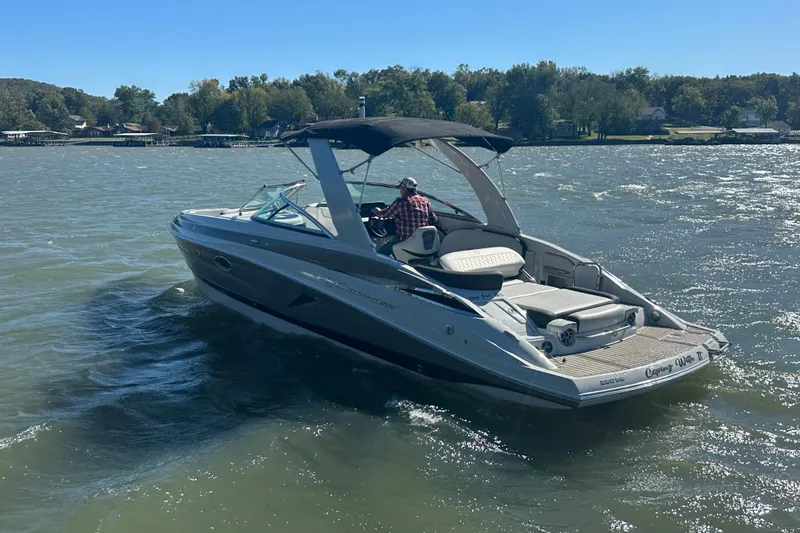 Slide: The Image of 2023 Crownline 290 CR boat cruising on a sunny lake. - 35