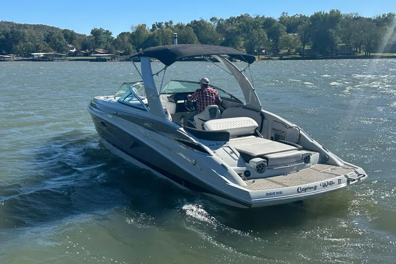 Slide: The Image of 2023 Crownline 290 CR boat cruising on a sunny lake. - 36