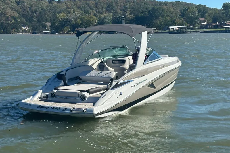 Slide: The Image of 2023 Crownline 290 CR boat cruising on a lake with scenic background. - 37
