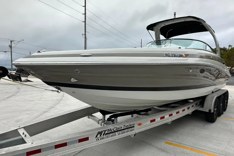 Slide: The Image of 2023 Crownline 290 CR boat on trailer, sleek design, parked outdoors. - 5