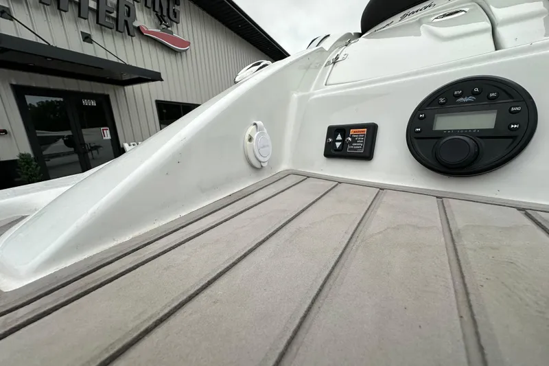 Slide: The Image of 2023 Crownline 290 CR boat deck with control panel and audio system. - 50