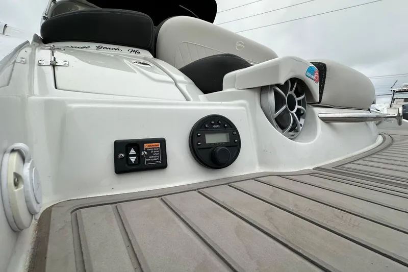 Slide: The Image of 2023 Crownline 290 CR boat deck with audio controls and speaker system. - 51