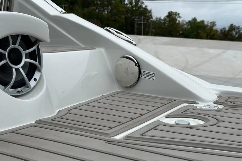 Slide: The Image of 2023 Crownline 290 CR boat deck with speaker and sleek design elements. - 52