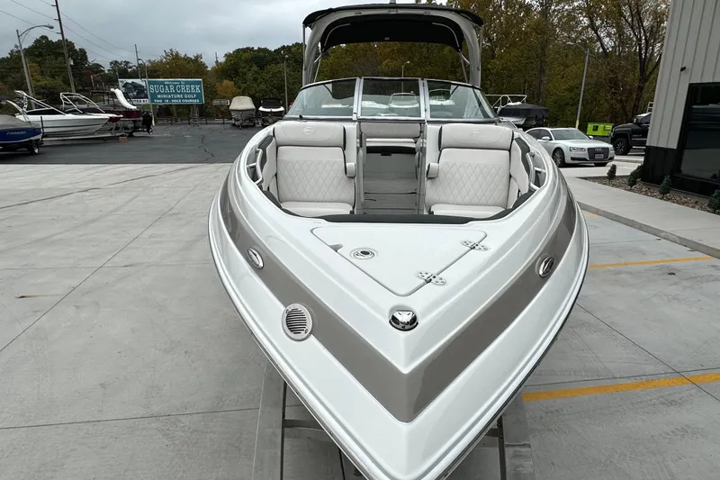 Slide: The Image of 2023 Crownline 290 CR boat with sleek design, parked outdoors. - 6
