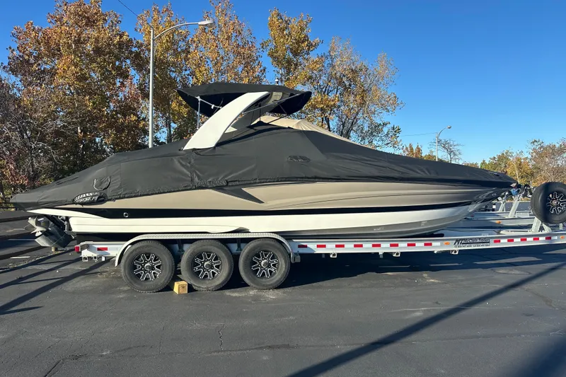 Slide: The Image of 2023 Crownline 290 CR boat on trailer, covered, parked outdoors. - 62