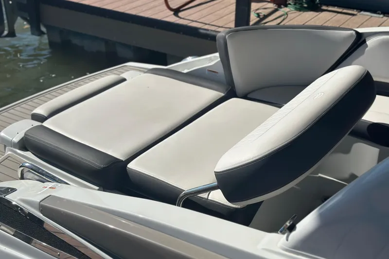 Slide: The Image of 2023 Crownline 290 CR boat with luxurious seating on a sunny dockside. - 9