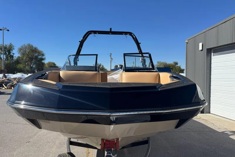 Slide: The Image of 2025 Moomba Max boat with sleek design, parked outdoors under clear blue sky. - 3