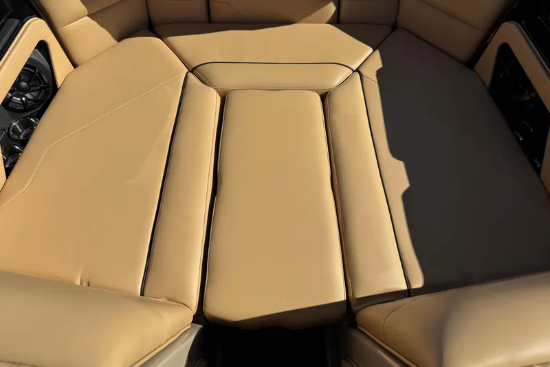 Slide: The Image of 2025 Moomba Max boat interior with tan leather seating and built-in speakers. - 4