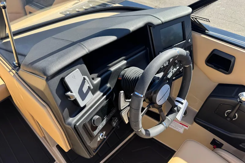 Slide: The Image of 2025 Moomba Max boat dashboard with steering wheel and control panel. - 5