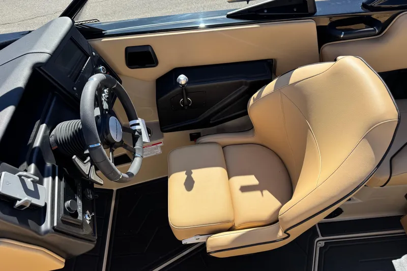 Slide: The Image of 2025 Moomba Max boat interior with tan leather seat and steering wheel. - 6