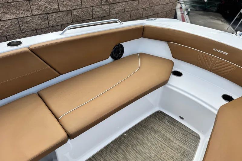 Slide: The Image of 2021 Glastron 205 boat interior with tan seating and cup holders. - 12