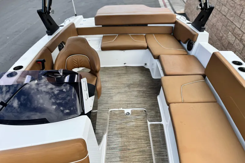 Slide: The Image of 2021 Glastron 205 boat interior with tan seating and modern design. - 14