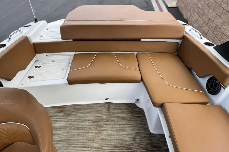 Slide: The Image of 2021 Glastron 205 boat interior with tan cushioned seating and white accents. - 16