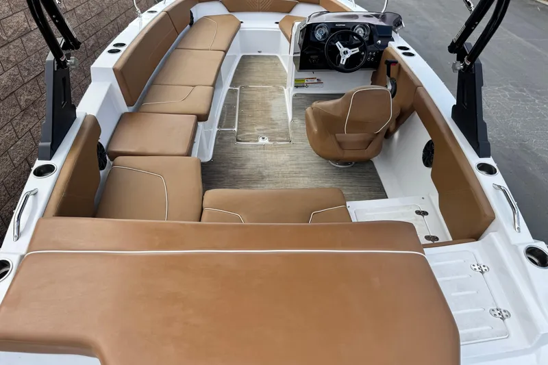 Slide: The Image of 2021 Glastron 205 boat interior with tan seating and modern dashboard. - 8
