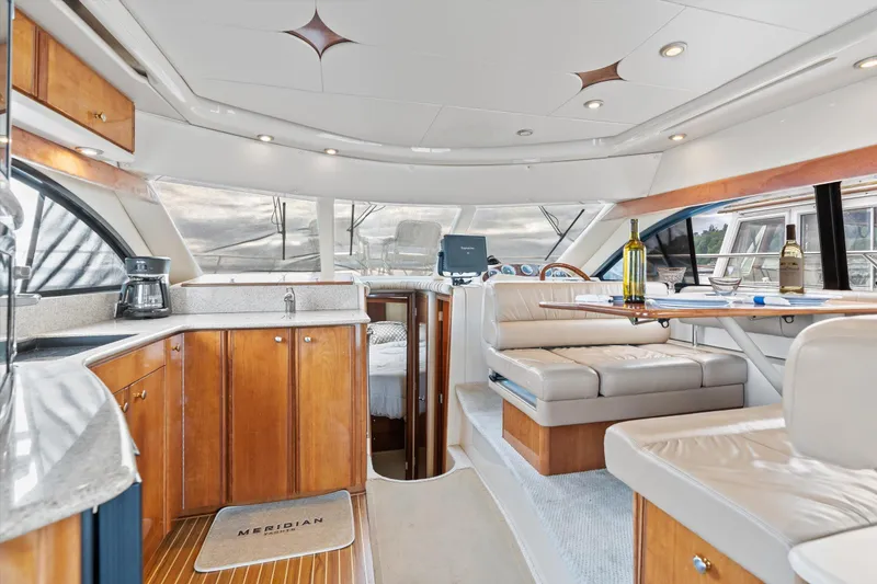 Slide: The Image of Luxurious interior of 2006 Meridian 411 Sedan yacht with elegant seating and kitchen area. - 11