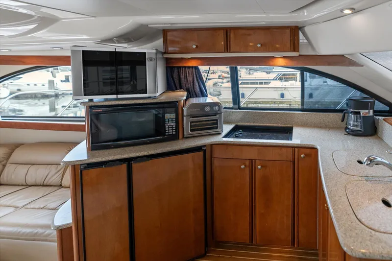 Slide: The Image of Interior of 2006 Meridian 411 Sedan yacht with kitchen appliances and wooden cabinetry. - 13