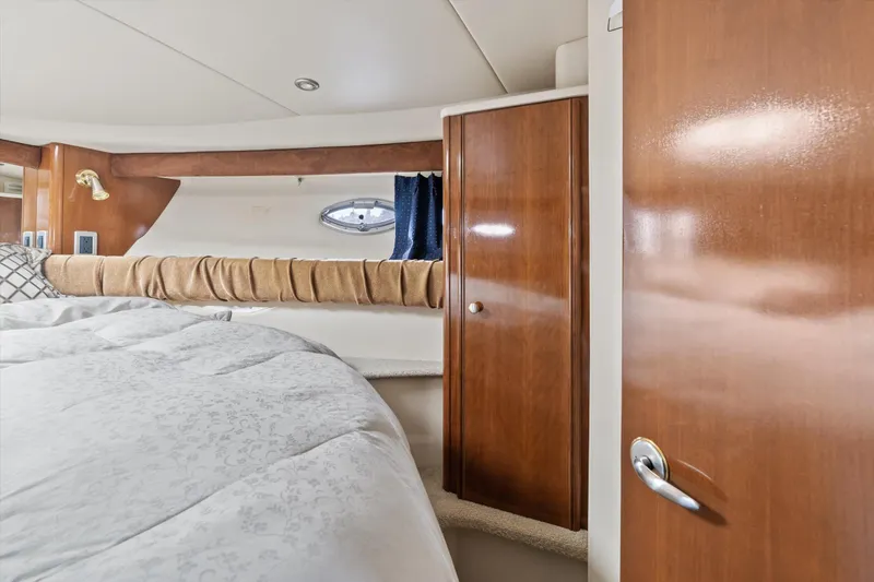 Slide: The Image of Luxurious interior of 2006 Meridian 411 Sedan yacht with wood finishes and cozy bedding. - 17