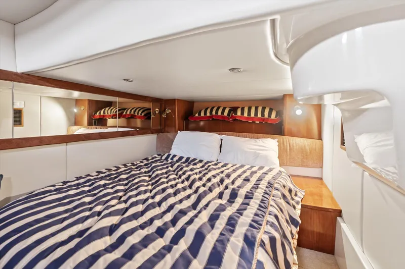 Slide: The Image of Luxurious cabin interior of 2006 Meridian 411 Sedan yacht with striped bedding. - 19