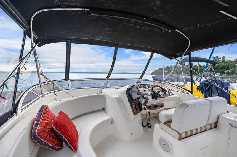 Slide: The Image of Interior of 2006 Meridian 411 Sedan yacht with helm, seating, and ocean view. - 2