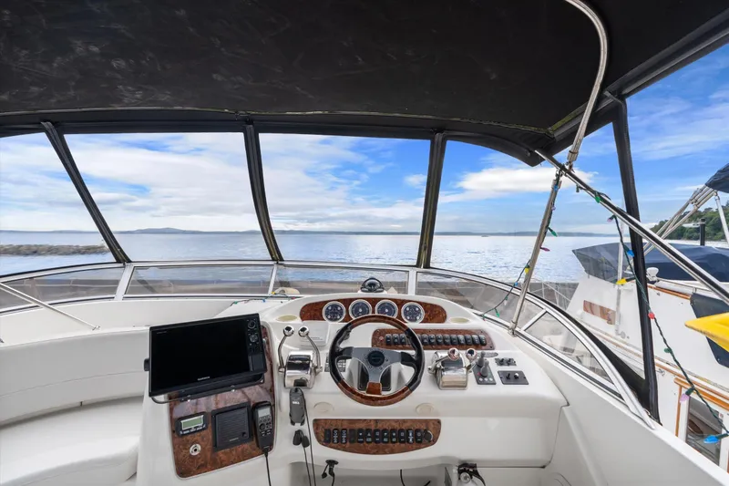 Slide: The Image of 2006 Meridian 411 Sedan helm with ocean view, featuring modern navigation equipment. - 22