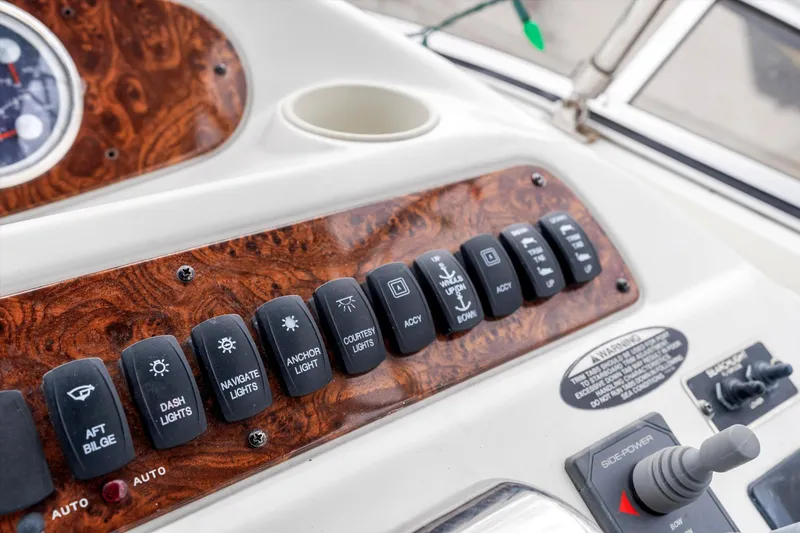 Slide: The Image of Control panel of a 2006 Meridian 411 Sedan boat with various switches and dials. - 24