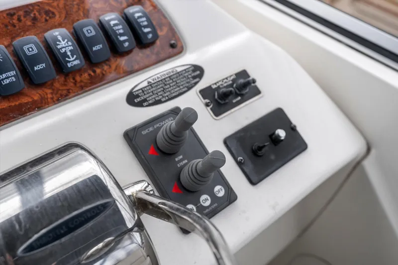Slide: The Image of Control panel of 2006 Meridian 411 Sedan boat with switches and levers. - 25