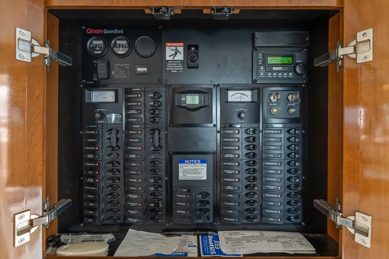 Slide: The Image of Electrical control panel inside 2006 Meridian 411 Sedan boat, featuring Onan GenSet system. - 27