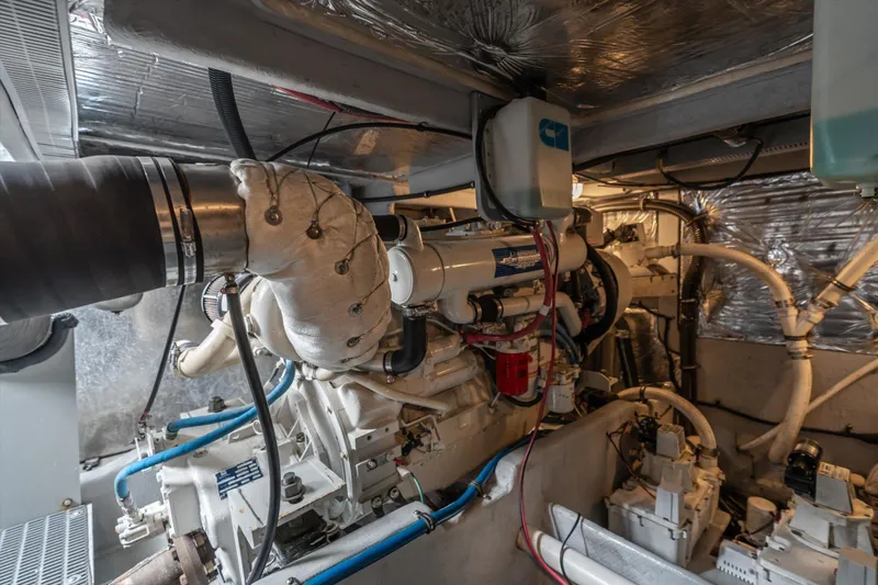 Slide: The Image of Engine room of a 2006 Meridian 411 Sedan yacht, showcasing mechanical components and wiring. - 32