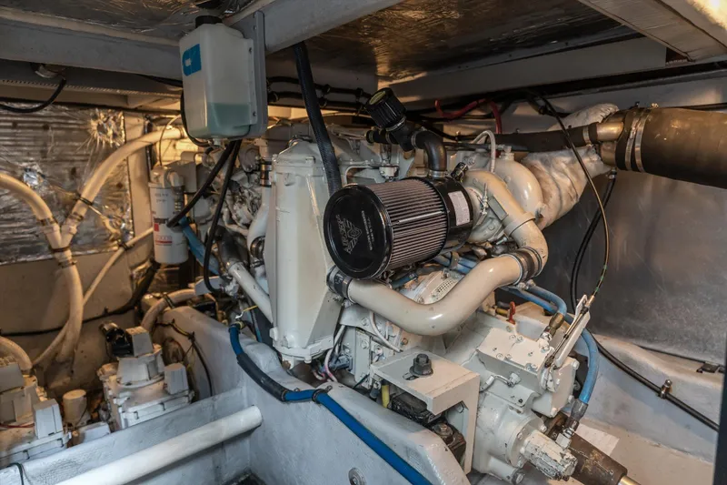 Slide: The Image of Engine room of a 2006 Meridian 411 Sedan yacht, showcasing mechanical components and piping. - 35