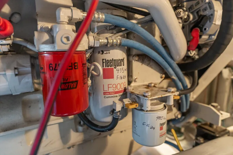 Slide: The Image of Engine components of a 2006 Meridian 411 Sedan, featuring filters and hoses. - 36