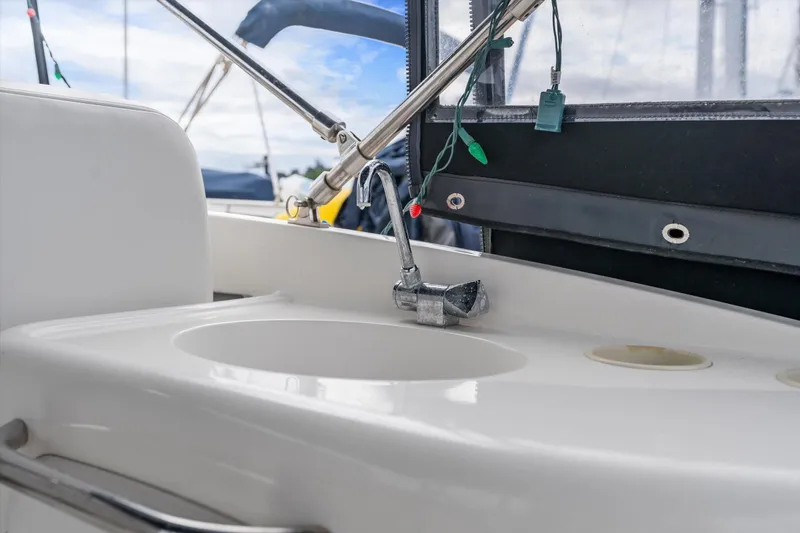 Slide: The Image of 2006 Meridian 411 Sedan boat sink with faucet and outdoor view. - 5