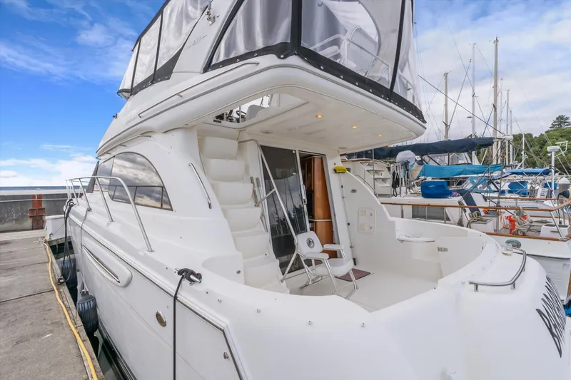 Slide: The Image of 2006 Meridian 411 Sedan yacht docked at marina, featuring spacious deck and modern design. - 6