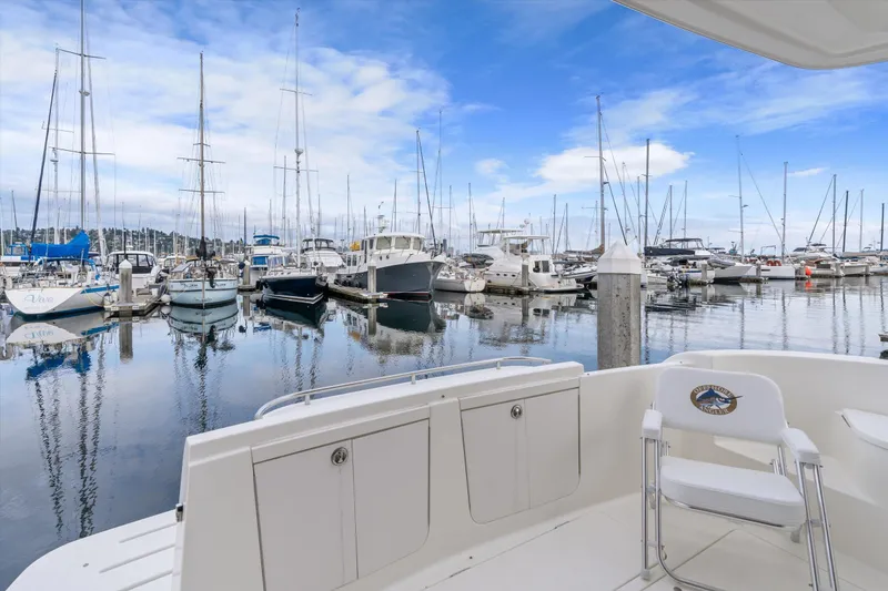 Slide: The Image of 2006 Meridian 411 Sedan yacht docked in a serene marina with sailboats. - 8