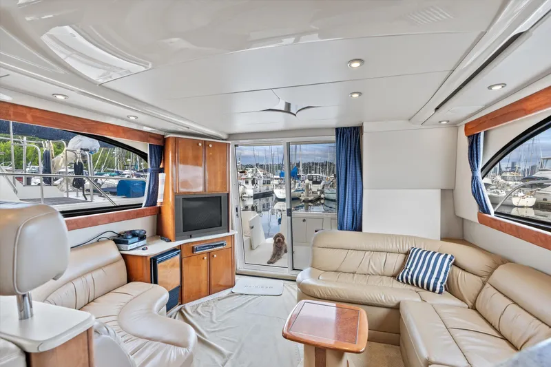 Slide: The Image of Luxurious interior of 2006 Meridian 411 Sedan yacht with leather seating and marina view. - 9