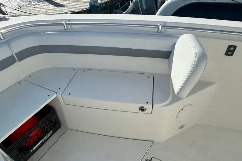 Slide: The Image of 2018 Cobia 227 boat interior with seating and storage compartments. - 10