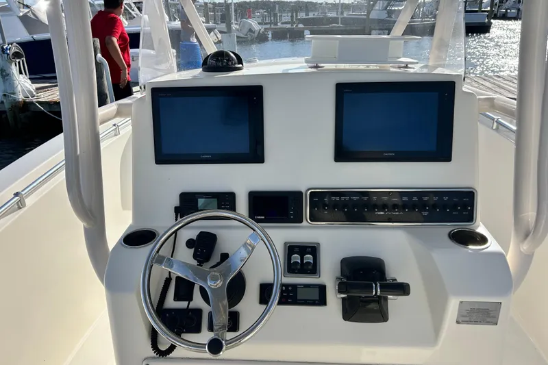 Slide: The Image of Helm of 2018 Cobia 227 boat with dual screens and steering wheel. - 4