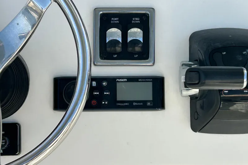 Slide: The Image of 2018 Cobia 227 boat dashboard with steering wheel, controls, and Fusion MS-RA70NSX stereo. - 6