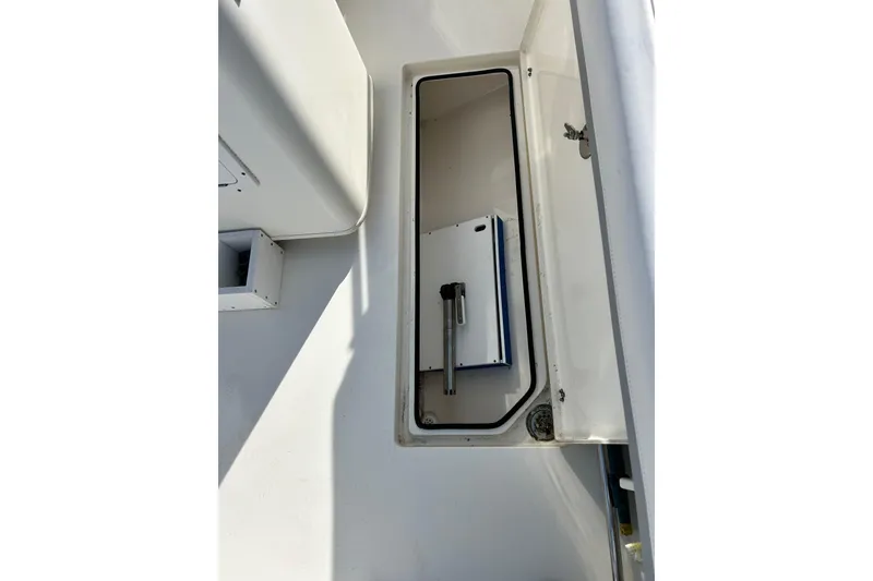Slide: The Image of 2018 Cobia 227 boat storage compartment with hatch open, showcasing interior space. - 7