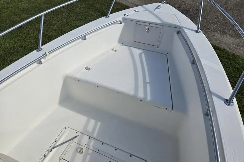 Slide: The Image of 2000 Scout 185 Sportfish boat deck with storage compartments and railing. - 12