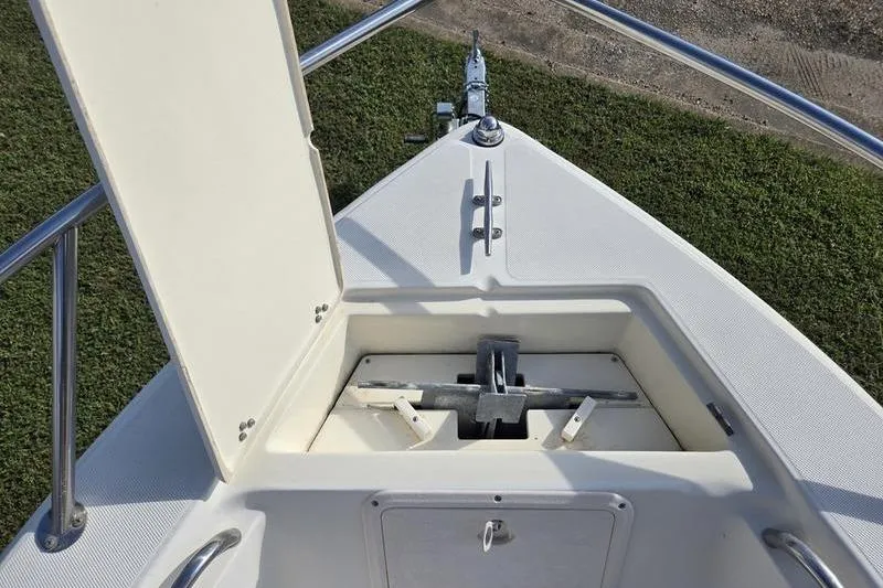 Slide: The Image of Bow view of 2000 Scout 185 Sportfish with open anchor compartment. - 15