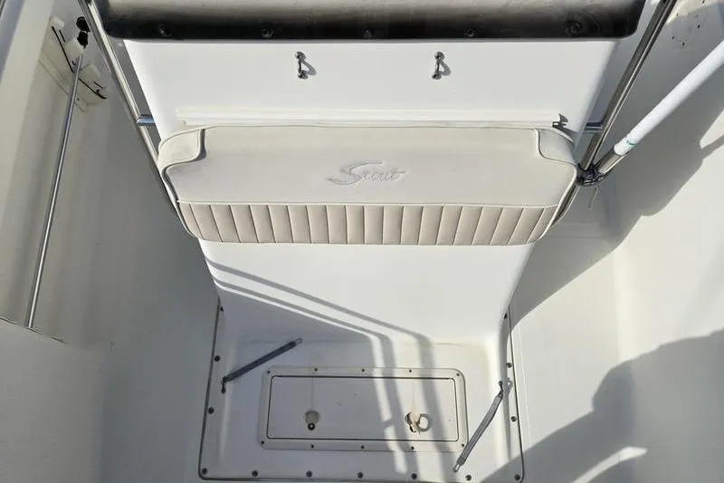Slide: The Image of Scout 185 Sportfish 2000 boat interior with cushioned seating and storage compartment. - 2