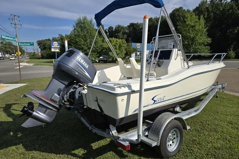 Slide: The Image of 2000 Scout 185 Sportfish boat with Yamaha motor on trailer, parked on grass. - 7