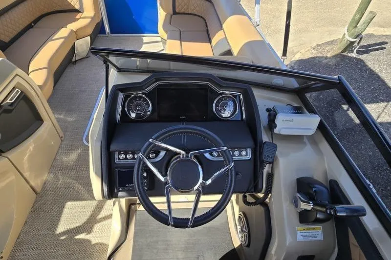 Slide: The Image of Interior view of 2023 Godfrey AquaPatio 255 SBW iMPACT boat, featuring steering console and seating. - 10