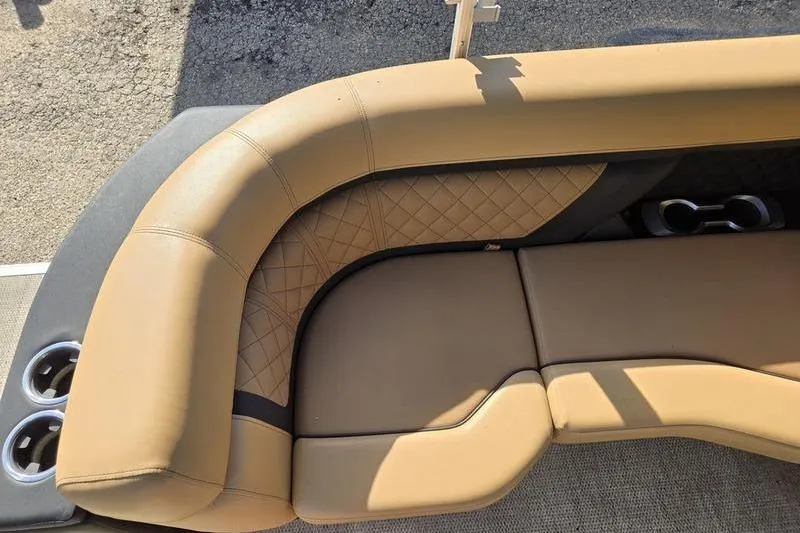 Slide: The Image of 2023 Godfrey AquaPatio 255 SBW iMPACT boat seating with tan upholstery and cup holders. - 19