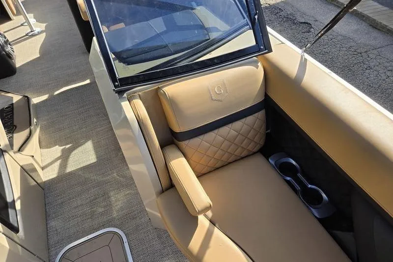 Slide: The Image of Luxurious seating on 2023 Godfrey AquaPatio 255 SBW iMPACT boat with tan upholstery. - 28